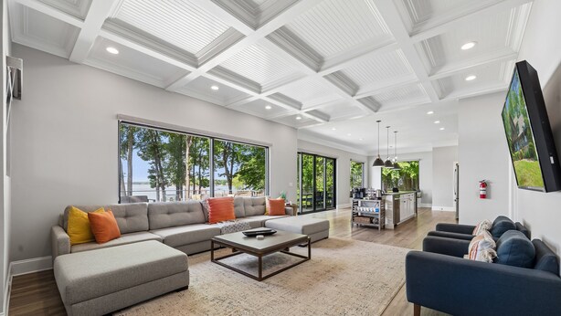 A spacious living area with a sectional sofa, a coffee table, and a television.