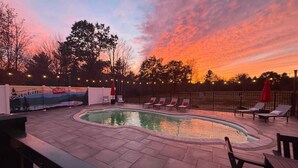 A swimming pool with lounge chairs and a mural on the wall. - NEW LISTING! Heated Pool + Sauna + Hot Tub + Game Room + Jungle Gym + Fire Pit (Windham)
