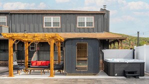 A two-story house with a covered patio area featuring outdoor furniture and a hot tub. - NEW LISTING! Heated Pool + Sauna + Hot Tub + Game Room + Jungle Gym + Fire Pit (Windham)