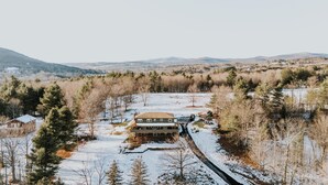 A large house with a long driveway and a snow-covered yard. - NEW LISTING! Heated Pool + Sauna + Hot Tub + Game Room + Jungle Gym + Fire Pit (Windham)