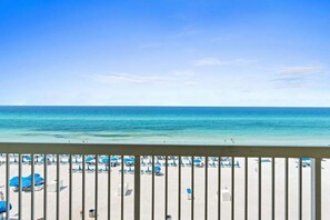 A beach view with a railing, beach umbrellas, and lounge chairs. - ☀️ Newly Updated Gulf-Front Condo | Stunning Views | Celadon 407 🌊 (Panama City Beach)