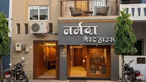 A two-story building with a sign reading 'Namda' and 'Gost House'. - Narmada Guest House (Indore)