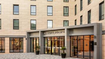 A hotel entrance with a sign reading 'AC HOTEL INVERNES'.