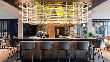 A modern bar area with a central island, bar stools, and a ceiling garden.