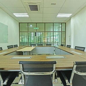 A conference room with a long table, chairs, and a view of the outside through large windows. - AK Cvia Hotel (Padang Besar)