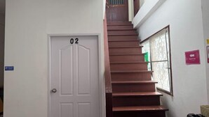 A staircase leading to a door labeled '02' with a window on the right side. - Sleep Break Hostel Sathon (Bangkok)