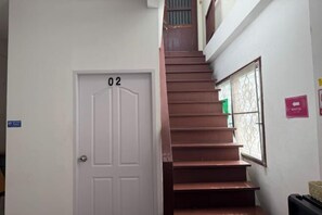A staircase leading to a door labeled '02' with a window on the right side. - Sleep Break Hostel Sathon (Bangkok)