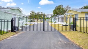A gated entrance to a residential area with houses labeled "Evergreen Cottages." - Charming Hideaway Cottage Pensacola (Pensacola)