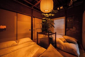 A traditional Japanese-style room with tatami flooring, a shoji screen door, and a hanging paper lantern. - Ivy Place Harajuku Urban Steel Teahouse (Tokyo)