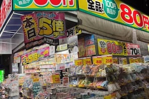 A store interior with various products on shelves and promotional signs. - GARDEN HOUSE (Osaka)