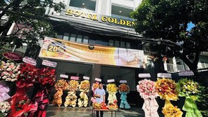 A hotel named "HOTEL GOLDEN" with a large sign and a flower stand in front. - Golden Hotel SG by BAY LUXURY (Ho Chi Minh City)