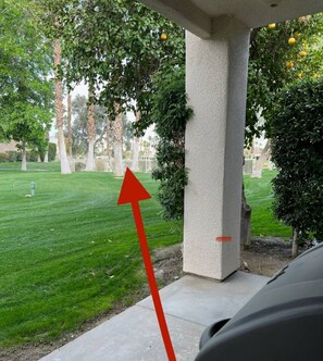 A concrete structure with a red arrow pointing to a pool area.