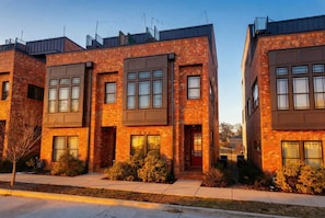 Brick townhouse exterior from the street, situated in a walkable Nashville neighborhood minutes from Centennial Park and the Parthenon. Steps away from dinner and live music venues - Rooftop skyline views near Broadway | sleeps 12 in Nashville (Nashville)