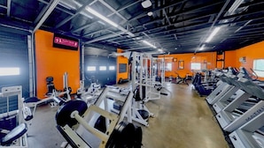 A gym with various exercise equipment, including treadmills and weight machines. - Hot Tub~Gym~5 Min to Mass Ave~Backyard Retreat~Indianapolis (Indianapolis)