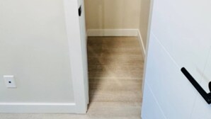 A narrow hallway leading to a closet with a metal shelf. - Beautiful walk out basement suit in south east Calgary (Calgary)