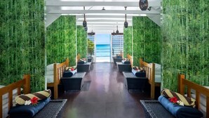 A corridor with bamboo walls leading to a beach view. - Oarsman's Bay Lodge - Adults Only (Nacula Island)