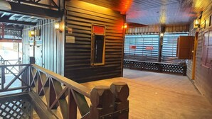 A wooden interior with a staircase, a metal railing, and a wooden door with a sign. - Collection O Baan Elephant Home (Chiang Mai)