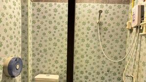 A bathroom with a toilet, a paper towel dispenser, and a shower with a hose. - Collection O Baan Elephant Home (Chiang Mai)