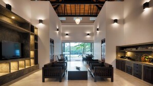 A modern kitchen with a large island, built-in appliances, and a view to the outdoors.