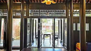 A covered walkway with a wooden ceiling and a central light fixture. - Lumiere Villa Hue (Hue)