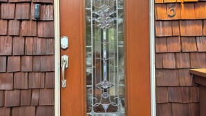 A wooden door with a glass panel and a metal handle, a number '3' sign, and a wall-mounted light fixture. - 2-bedroom home in Sedona on the creek (Sedona)