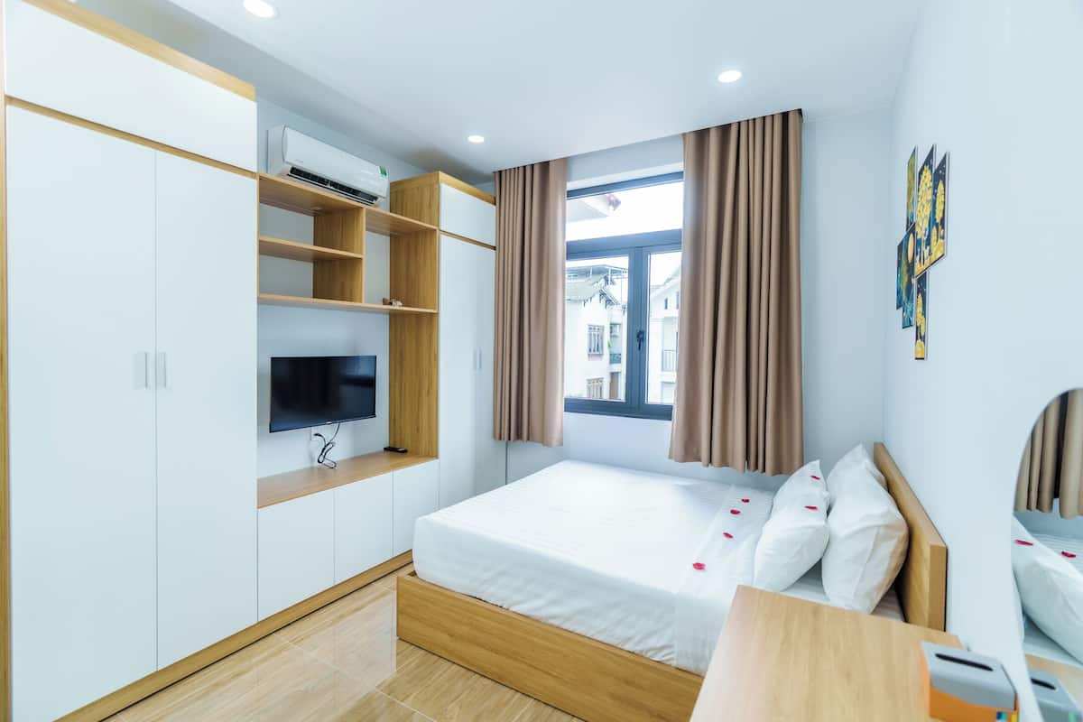 Superior Studio | Desk, laptop workspace, blackout curtains, iron/ironing board