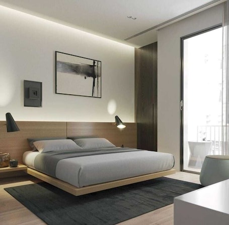 A modern bedroom with a bed, bedside lamps, a framed artwork, and a view through a large window.. Pari Ac Restaurant & Hotel