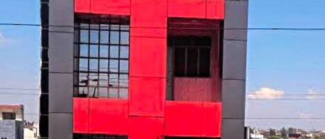 Um edifício vermelho e cinzento com uma placa de identificação no topo.