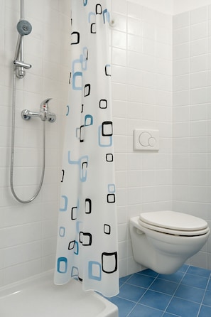 A bathroom with a shower, toilet, and blue-tiled floor. - Casa Giorgia, a confortable and amazing place in centre of Cormons (Cormons)