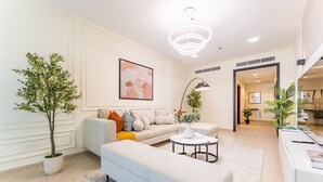 A modern living room with a sofa, a coffee table, and a potted plant.