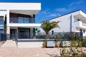 A modern two-story residential building with a balcony, a gated entrance, and a paved driveway. - Villa Emma With Pool and sea view (Medulin)