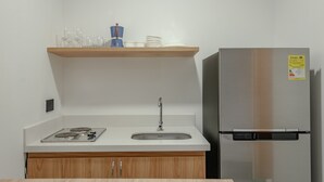 A kitchen with a stainless steel refrigerator, a double sink, and a wooden countertop. - NOK Amazing Loft in Laureles (Medellín)