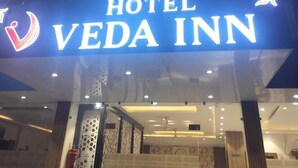 A hotel sign for VEDA INN with a modern design and illuminated letters. - Hotel Veda Inn By Blue Lotus (Rishikesh)
