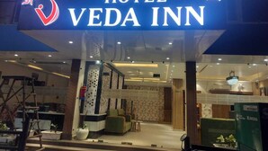 The entrance of Hotel Veda Inn with a modern interior visible through the glass doors. - Hotel Veda Inn By Blue Lotus (Rishikesh)
