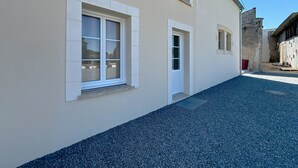 A building with a paved driveway and a small courtyard.