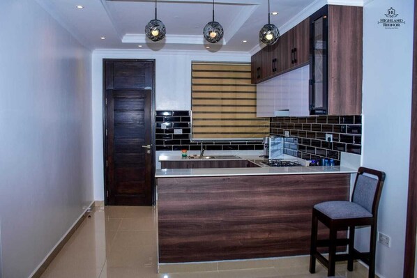 Superior studio suite, uitzicht op de stad | Privékeuken | Een koelkast, een microgolfoven, kookgerei, borden en bestek