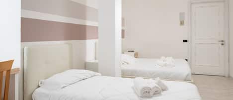 Triple Room | Minibar, in-room safe, desk, cots/infant beds