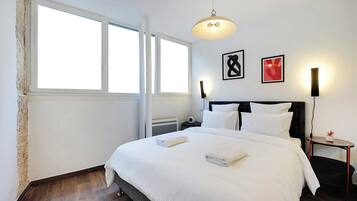 Laptop workspace, iron/ironing board, bed sheets