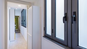 A hallway with a door leading to a bathroom. - Metro Università Apartment by Wonderful Italy (Naples)