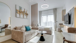 A modern living room with a sofa, a coffee table, and a TV.