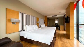 A hotel room with two beds, a TV, and a view of the city. - Sunday Hotel Subang (Subang Jaya)