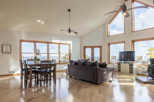 Upstairs living area with panoramic Lake Huron and Straits of Mackinac views — the best seat in St. Ignace and it's inside your cabin