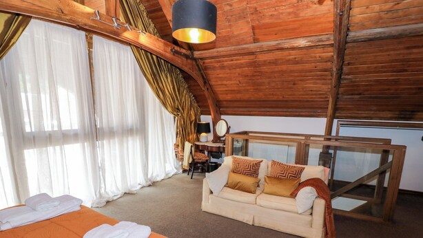 A room with a bed, a sofa, and a desk. - Diamond Lodge (Stafford)