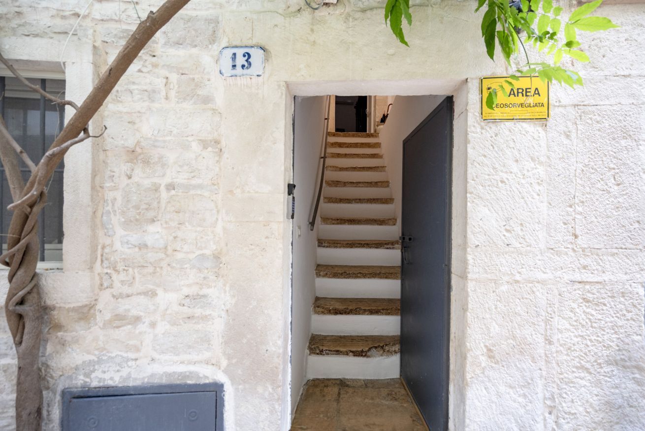 A staircase leading to a door with a number 13 sign above it.