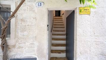 A staircase leading to a door with a number 13 sign above it.