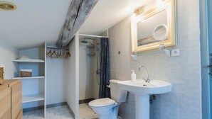 A bathroom with a toilet, sink, shower, and a mirror. - Chambre d'hôtes - B&B - Fleur de Coton (Lagnes)