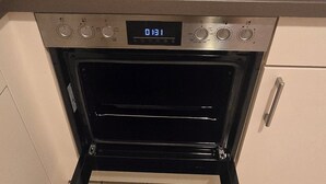 A kitchen with a built-in oven and a digital display. - Beautiful vacation apartment in Timmendorfer Strand (Timmendorfer Strand)