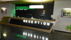A reception desk with a sign reading "RECEPTION" and "SEA TOWERS BLOCK". - Batumi Royal Apartments (Batumi)
