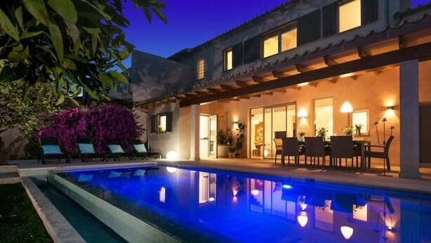 A modern house with a swimming pool, outdoor seating, and a well-lit patio area. - Bouganvilla House FOR 6 PERSONS (Ariany)