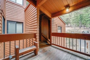 A wooden cabin with a balcony, a bench, and a view of the surrounding forest. - Ski-in/ski-out Northstar Condo w/ Gondola View (Truckee)